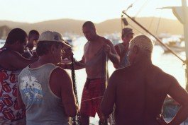 Fishing community gathering during sunset at a marina. 