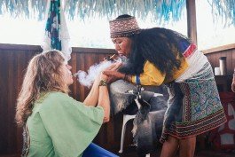 Robin Mellor - Woman performing a traditional healing ritual with smoke in a cultural setting. 