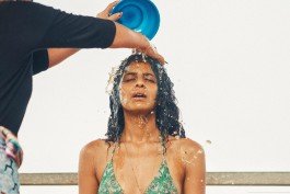 Robin Mellor - Woman being baptized with water pouring over her head during a baptism ceremony. 