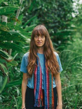 Robin Mellor in lush green garden surrounded by tropical plants.