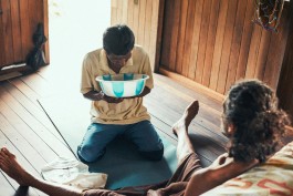 Healer performing a spiritual or energy healing ritual on a seated patient. 