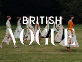 Models in floral dresses walk across a green lawn in a fashion shoot, with oversized 'BRITISH VOGUE' white lettering overlaid. 