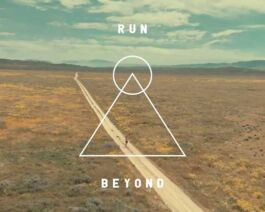 Run Beyond - Inspirational outdoor running scene with a lone runner on a dirt trail. 
