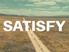 Desert landscape with a straight dirt road to the horizon; large white text 'SATISFY' across the image. 